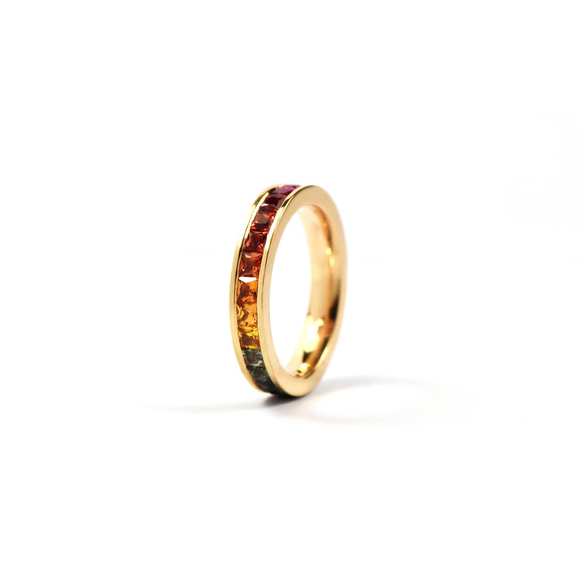 O'Dwyer Red Gold Rainbow Channel Set Ring. Tis ring is crafted from 18ct red gold. It is channel set with a rainbow of carré sapphires, bringing joy and love to every person that sees it. 
